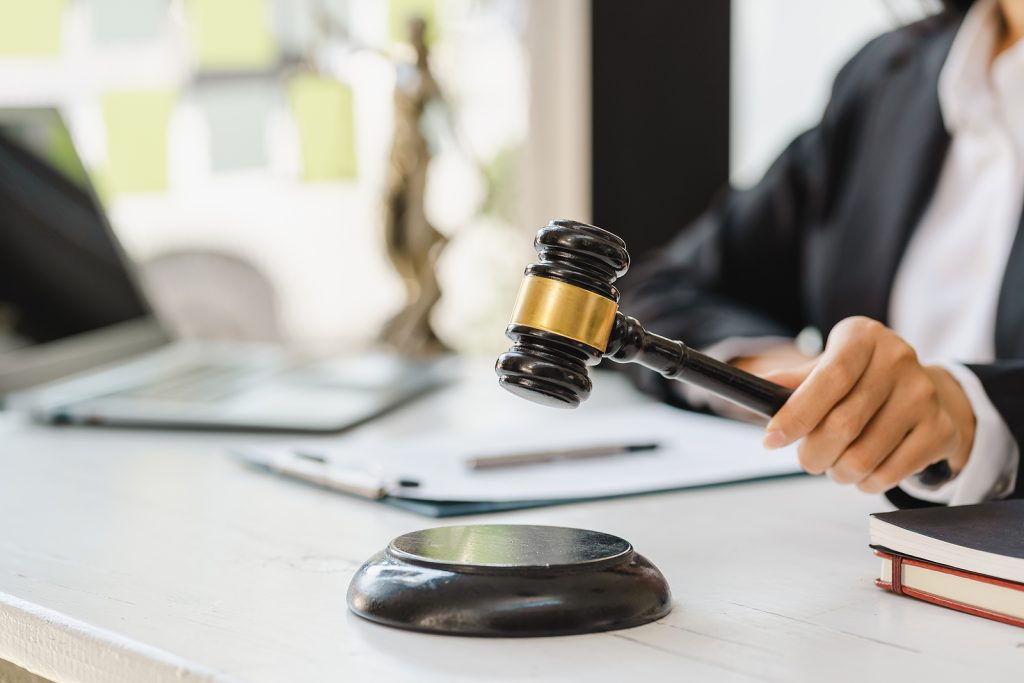 Woman judge hand holding gavel